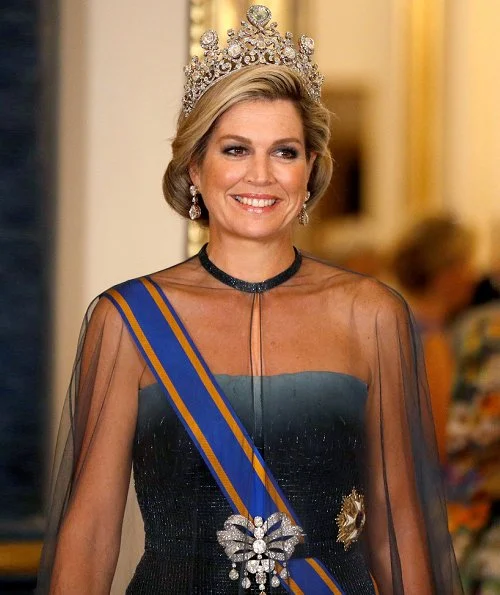 Kate Middleton's wearing the Lovers Knot Tiara, Diana's Collingwood earrings and blue McQueen gown. Maxima' Jan Taminiau gown and pearl tiara