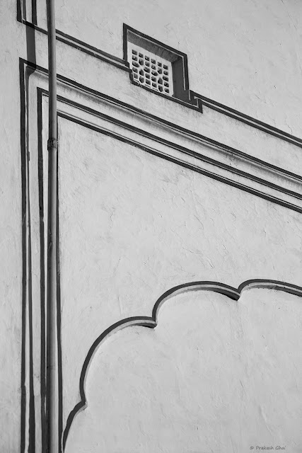 A Black and White Minimal Art Photograph of Lines Curves and Square as seen on a Wall at Diggi Palace, Jaipur.