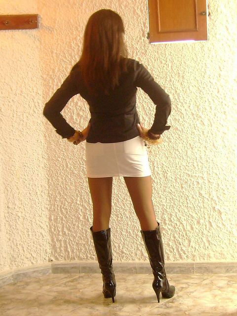 Sexy crossdresser showing off her beautiful legs in pantyhose and boots