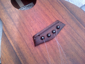 Drilling bridge hole for installing ukulele pickup