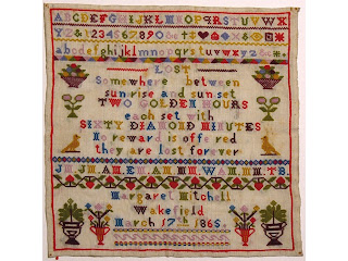 A child's educational stitched sampler of the alphabet