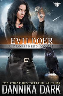 Darkhaired woman standing in moonlight with a gold key in her hand. Raven sitting on a post