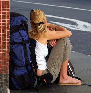 Backpacker with backpack, resting