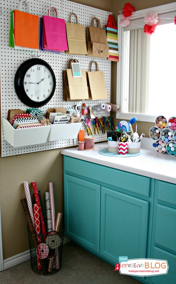 4. Craft Room Corner Wrapping Station. I love how this wrapping station fits perfectly into the corner of an entire craft room. The wire basket is a functional and beautiful solution to storing rolls of wrapping paper. 