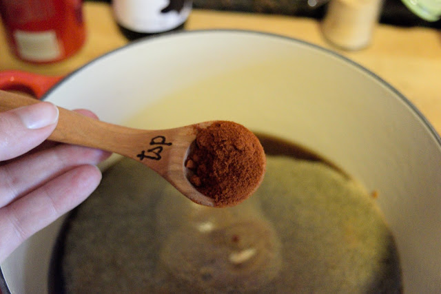 Smoked paprika being added to the pot for the bbq sauce