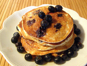 Blueberry Pancakes Garnished with Blueberries and Maple Syrup