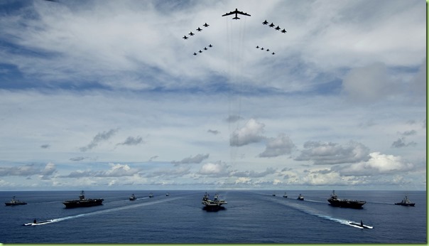 USS KITTY HAWK, at sea - A U.S. Air Force B-52 leads a formation of Air Force and Navy F-16, F-15, and F-18 aircraft over the USS Kitty Hawk (CV 63), USS Nimitz, and USS John C. Stennis Strike Groups during Valiant Shield's photo exercise Aug.14 (Guam time). The forces participated in Valiant Shield, the largest joint exercise in the Pacific this year. Held in the Guam operating area, the exercise includes 30 ships, more than 280 aircraft and more than 20,000 service members from the Navy, Air Force, Marine Corps, and Coast Guard. (U.S. Navy photograph by Mass Communication Specialist 2nd Class Jarod Hodge)