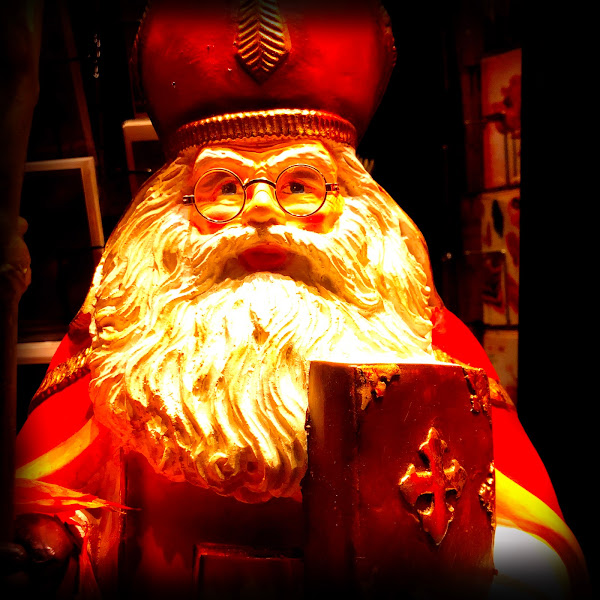 Sinterklaas met leesbril in etalage van boekhandel