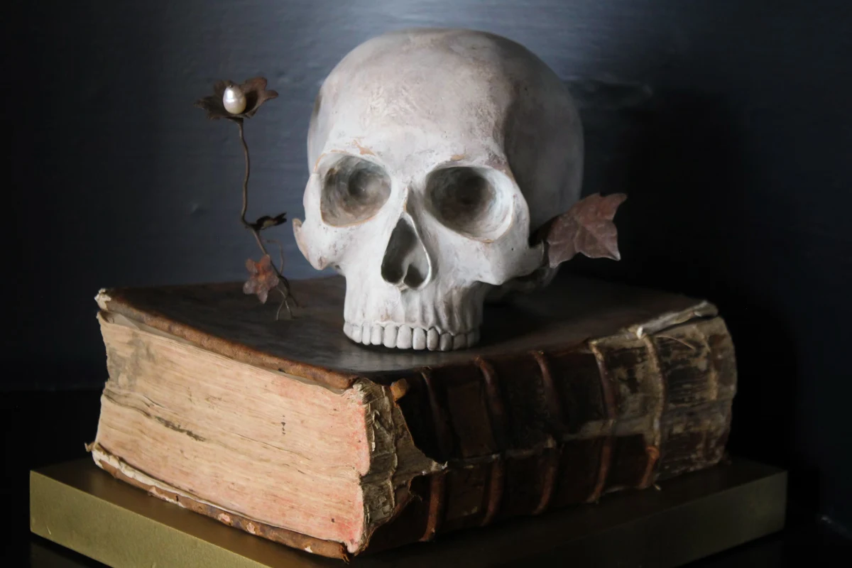 decorative skull on top of vintage books