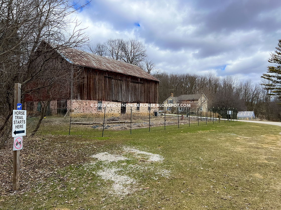 a barn next to a garden