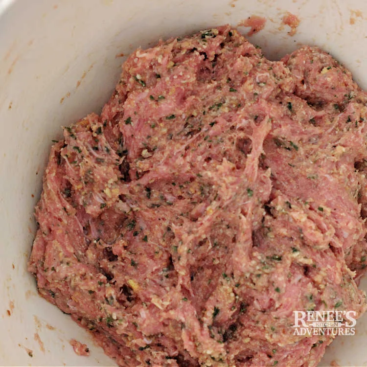 Mixture for air fryer turkey meatballs mixed in bowl and ready to be formed into meatballs