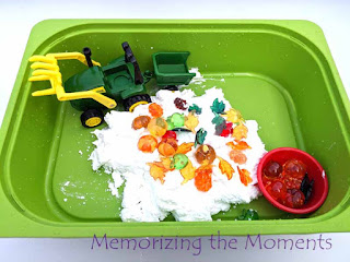 Fall tractor sensory play with apples, pumpkins and leaves