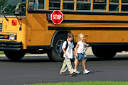 Walking home from the school bus stop, he would wonder. (school bus)