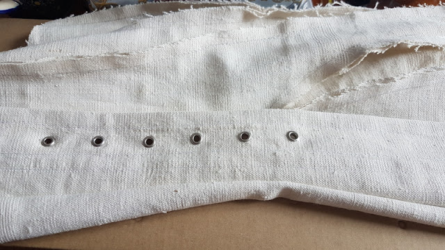 white linen edwardian corset with half of its eyelets stamped into it