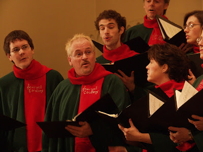 Pierre Massie directs the Stairwell Carollers from within the Tenor section