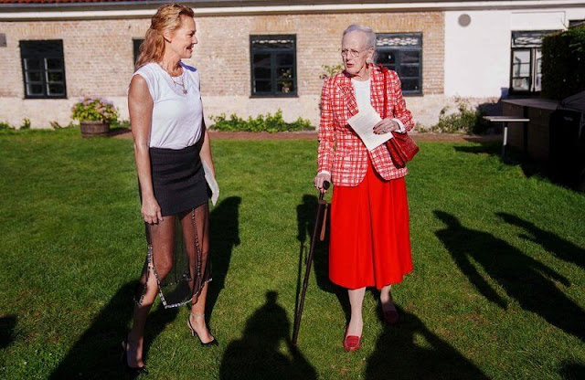 Queen Margrethe wore a red checked blazer and a white silk blouse and a red midi skirt. Danish actress Connie Nielsen