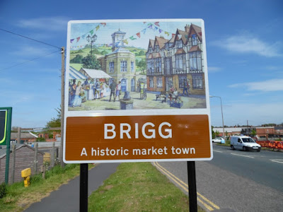 Picture of one of the Welcome to Brigg signs beside the A18