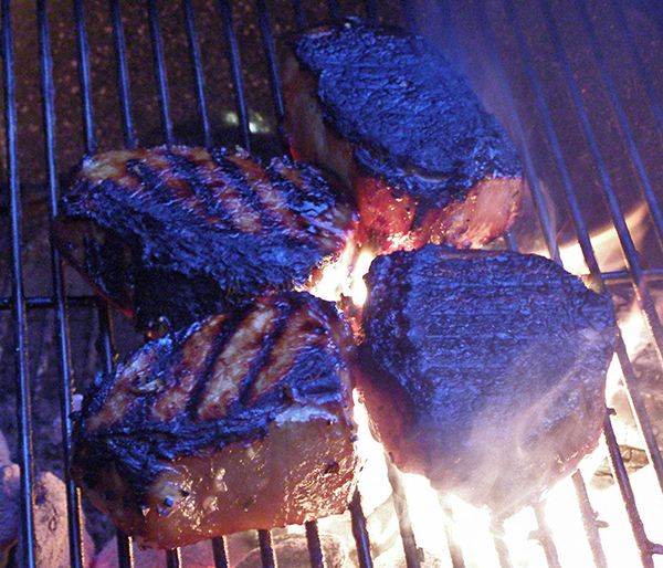 4 pork chops on hot part of grill