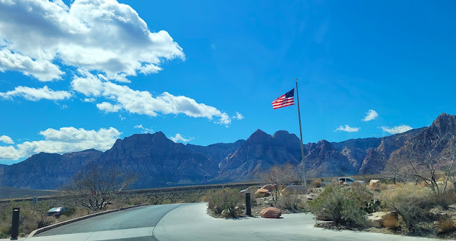 American Flag flying high and proud with beautiful mountain on the background