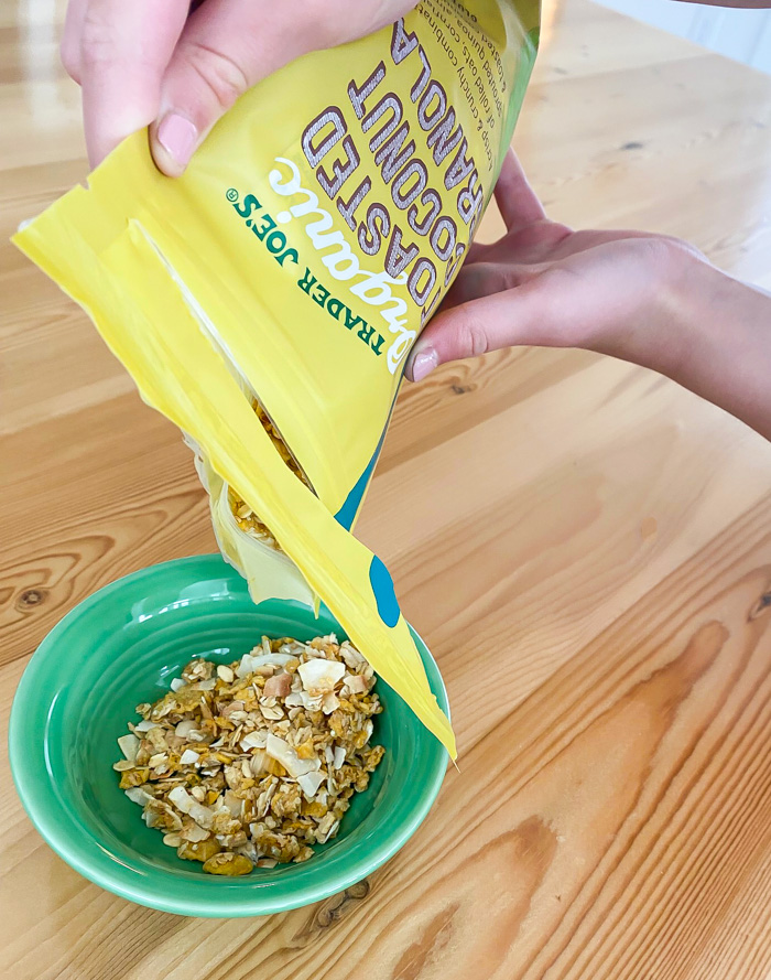 Trader Joe's Organic Toasted Coconut Granola being poured into bowl