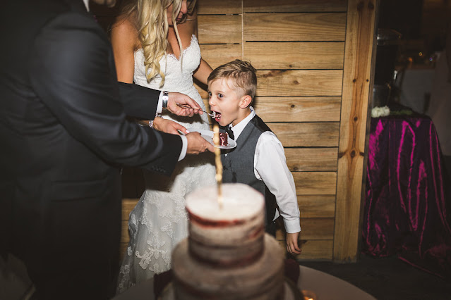 bride and groom with cake and child