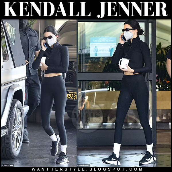 Kendall Jenner in black crop top, leggings and sneakers