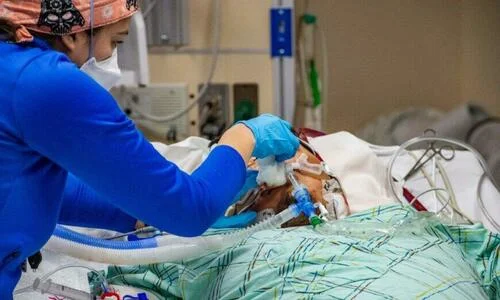 A medical worker treats an intubated unvaccinated 40 year old patient who is suffering from the effects of Covid-19 in the ICU at Hartford Hospital in Hartford, Connecticut on January 18, 2022.
