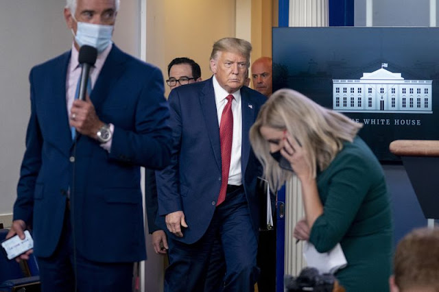 President Donald Trump returns to a news conference in the James Brady Press Briefing Room after he briefly left because of a security incident outside the fence of the White House