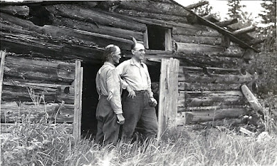 Two men at a cabin