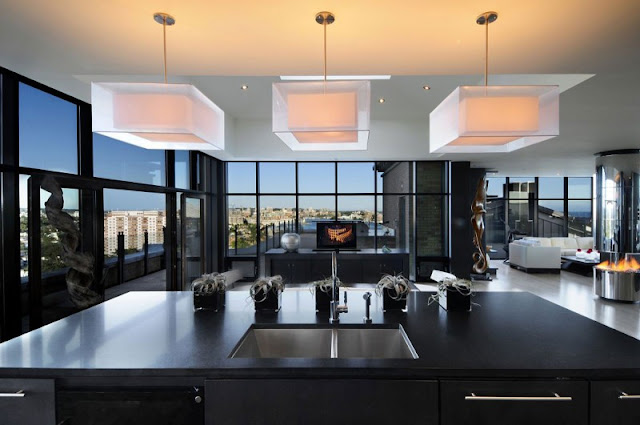 Picture of modern black kitchen island and the movie room behind it