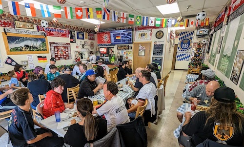 Fans in the full restaurant concentrate on the match