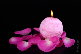 Decorative New Years Eve pink Candle in flower petals