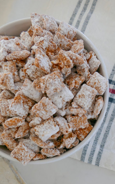 Close up of muddy buddies in a white bowl.