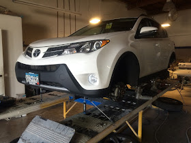 2015 Toyota RAV4 on frame rack being straightened after collision.