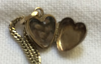 Open heart-shaped locket containing braid of hair