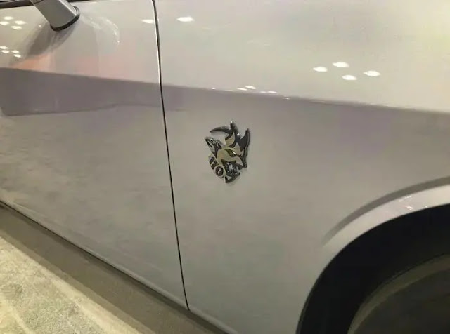 A small silver badge depicting a demon's head on the front fender of the Dodge Challenger SRT Demon 170.