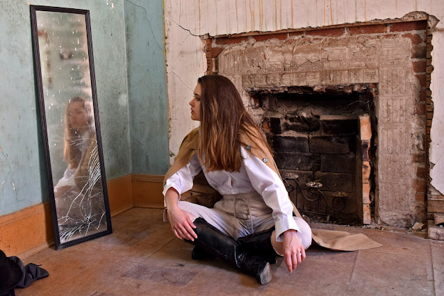 Model Audrey looks at the ghostly girl in the mirror at Preston Castle Ione California