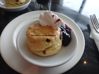 scone with whipped cream and jam