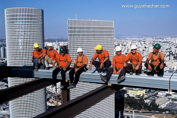 Skyscraper in Tel Aviv Construction workers on the skyscraper in Tel Aviv