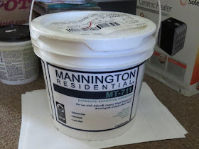 a bucket of Mannington Residential T-711 adhesive.