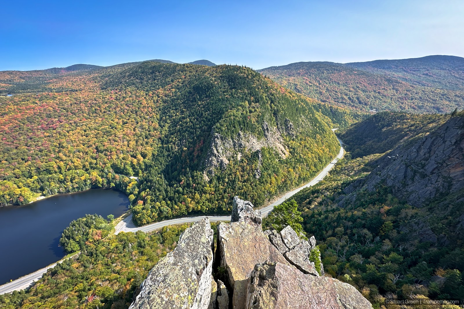 Looking over the end of table rock at Dixville Notch with a 700 foot drop to distant scenery.