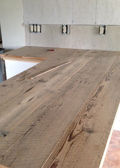 DIY Reclaimed Wood Countertop - gluing and nailing down reclaimed wood boards