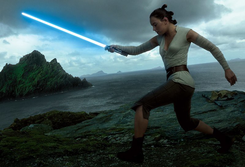 Daisy Ridley as Rey with lightsaber