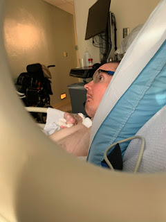 Chris watching tv in the hospital