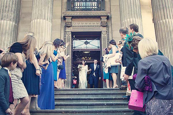 guests throwing confetti at Marylebone Town Hall wedding