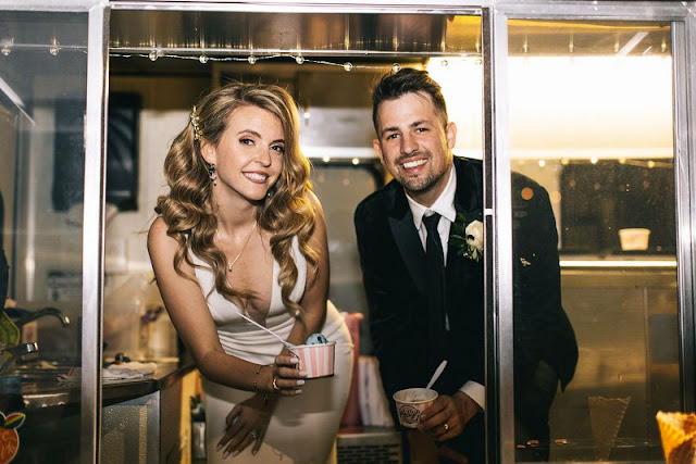 bride and groom smiling in food truck