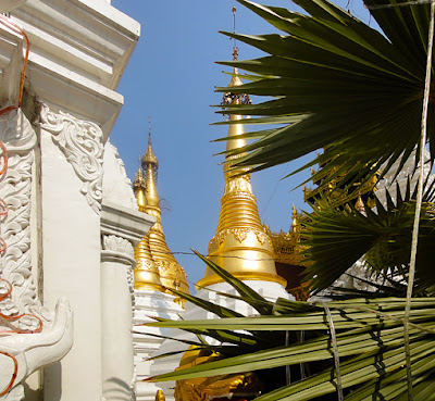 Golden and white pagodas on the platform in Yangon