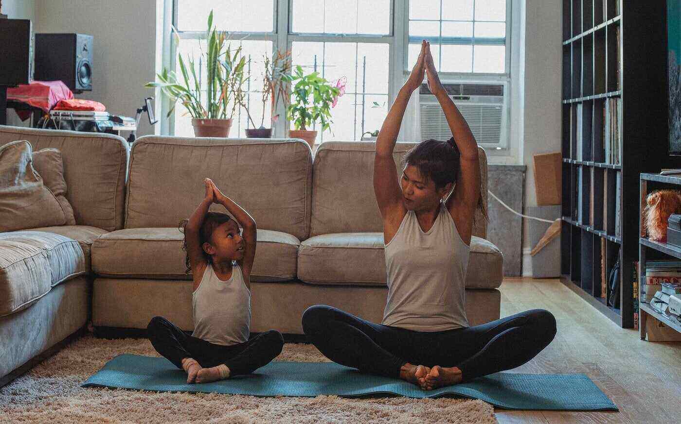 mother and daughter practicing yoga together - the work life balancing act