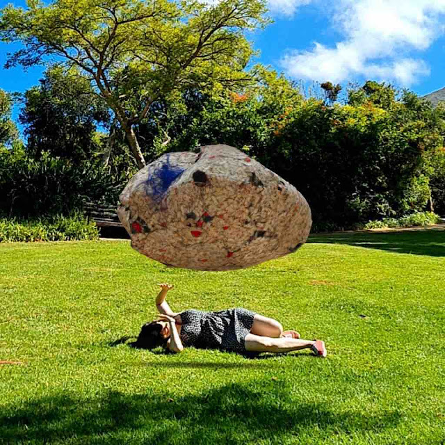 Woman interacts with AR rock levitating in a real garden