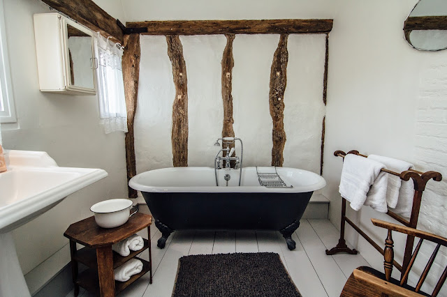 Roll top bath in rustic bathroom